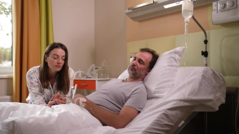 Stock Footage Worried Wife At Her Husbands Bedside Live Wallpaper Free - Free Live Wallpaper