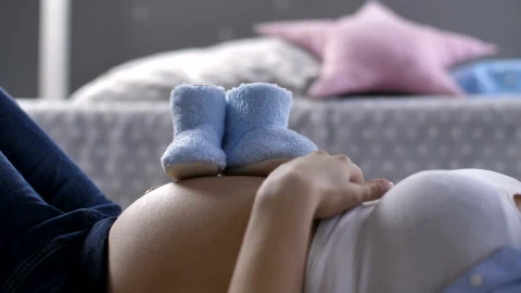 Stock Footage Woman Laying Down With Baby Shoes Live Wallpaper Free - Free Live Wallpaper