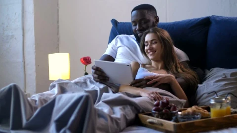 Stock Footage Young Couple Enjoying A Film In Bed Live Wallpaper Free - Free Live Wallpaper
