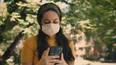 Stock Footage Woman In A Mask Sends Messages On Her Smart Phone Live Wallpaper Free - Free Live Wallpaper