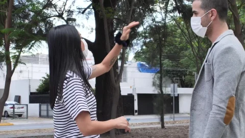 Stock Footage Woman Giving Directions To A Man With A Face Mask Live Wallpaper Free - Free Live Wallpaper