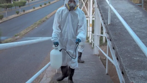 Stock Footage Workers In Hazmat Suits On A Pedestrian Bridge Live Wallpaper Free - Free Live Wallpaper