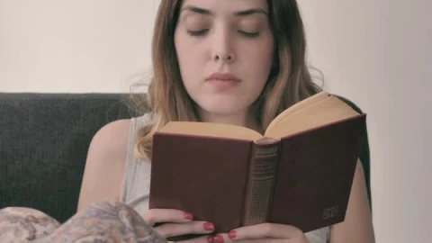 Stock Footage Young Woman Lying On A Sofa Reading A Book Live Wallpaper Free - Free Live Wallpaper