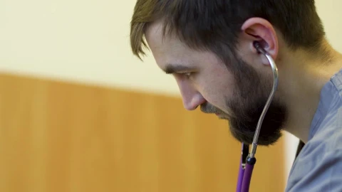 Stock Footage Young Doctor Listening Through His Stethoscope Live Wallpaper Free - Free Live Wallpaper