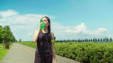 Stock Footage Woman In Activewear Drinking Water After Running Live Wallpaper Free - Free Live Wallpaper