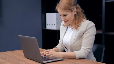 Stock Footage Woman Working In An Office Flips Smiling Live Wallpaper Free - Free Live Wallpaper