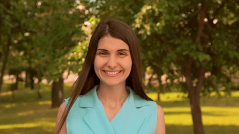 Stock Footage Woman Smiling Head On In A Beautiful Park Live Wallpaper Free - Free Live Wallpaper