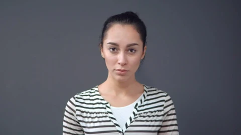 Stock Footage Young Sad And Serious Woman On A Gray Background Live Wallpaper Free - Free Live Wallpaper