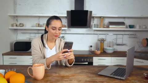 Stock Footage Woman In A Kitchen Typing On Her Smartphone Live Wallpaper Free - Free Live Wallpaper