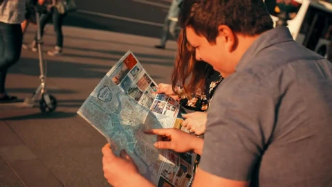 Stock Footage Young Tourists Locating Themselves On A Map Live Wallpaper Free - Free Live Wallpaper