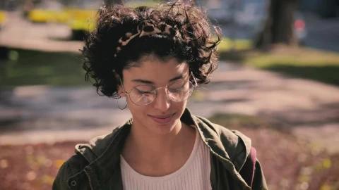 Stock Footage Woman Putting On Headphones In The Park Live Wallpaper Free - Free Live Wallpaper