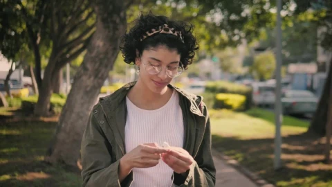 Stock Footage Woman Putting On Headphones While Going For A Walk Live Wallpaper Free - Free Live Wallpaper