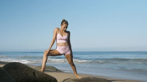 Stock Footage Woman Doing Yoga On Boulders On The Beach Live Wallpaper Free - Free Live Wallpaper