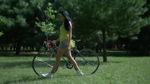 Stock Footage Woman Walking Her Bike Through Park Live Wallpaper Free - Free Live Wallpaper